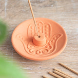 Hamsa Terracotta Incense Plate, 9 cm wide, featuring an intricate Hamsa design for incense sticks, ideal for spiritual spaces.