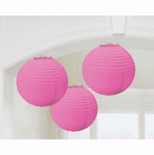 Vibrant pink round paper lanterns, 24cm, perfect for decorating events and creating an inviting ambiance. Pack of 3.