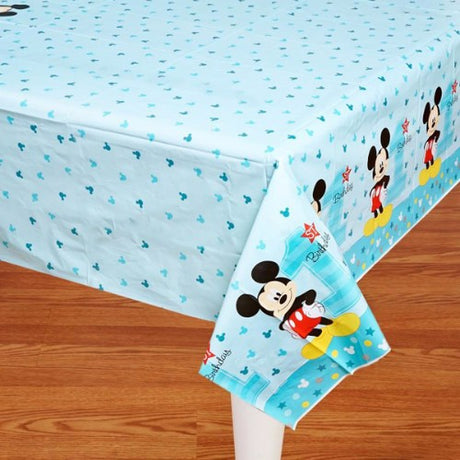 Mickey 1st Birthday Tablecover features vibrant designs, perfect for a fun and colorful first birthday celebration.