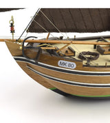 1/35 scale model kit of the Dutch fishing boat Botter with laser-cut parts, hand-sewn sails, and a wooden display base.