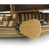 1/35 scale model of the Dutch fishing boat Botter with laser-cut parts, cotton sails, and wooden exhibition base.