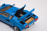 Diecast model of a blue Lamborghini Countach 5000S, featuring opening doors and detailed engine, perfect for collectors.