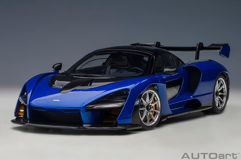 1/18 McLaren Senna diecast model in blue, featuring intricate details, realistic wheels, and a finely detailed interior.