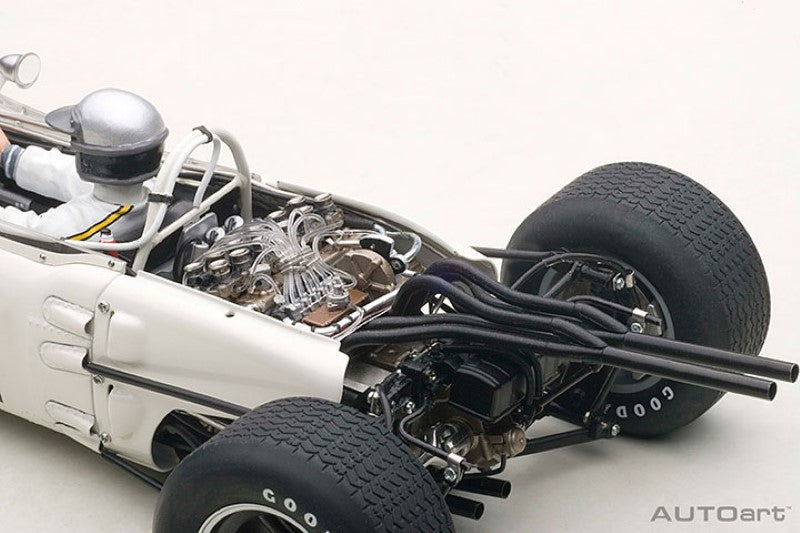 Diecast model of the '65 Honda RA272 #11 driven by Richie Ginther, featuring vibrant paint, opening hood, and detailed driver figure.