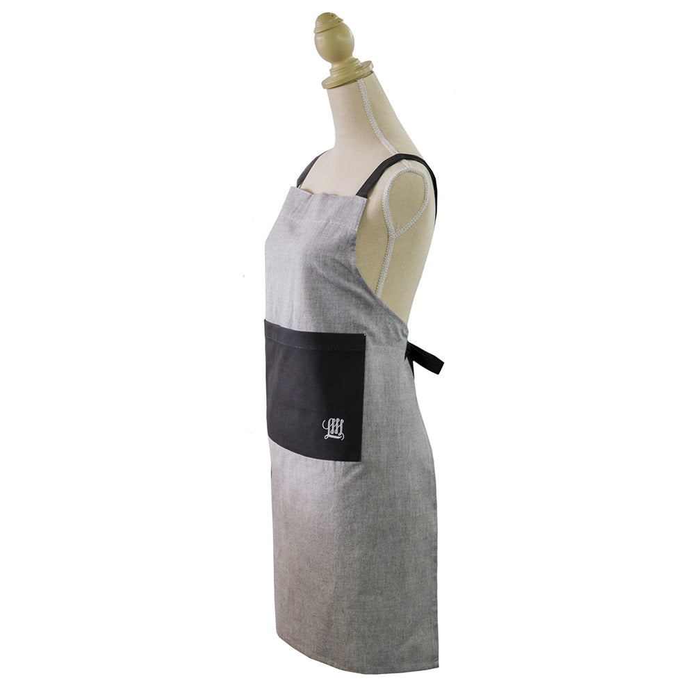 Grey chambray apron with adjustable neck strap and pockets, perfect for stylish cooking and protecting clothes.