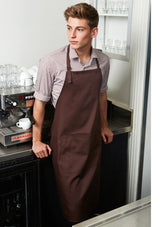 Bright red bib apron from Biz Collection with adjustable straps, front pocket, and towel loop for versatile kitchen use.