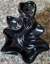 Elegant black backflow burner creating a calming atmosphere with downward-flowing incense smoke for relaxation and decor enhancement.