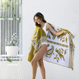 Luxurious Playa Beach Towel in durable cotton, featuring a velour finish and contemporary fringe, ideal for the beach or pool.