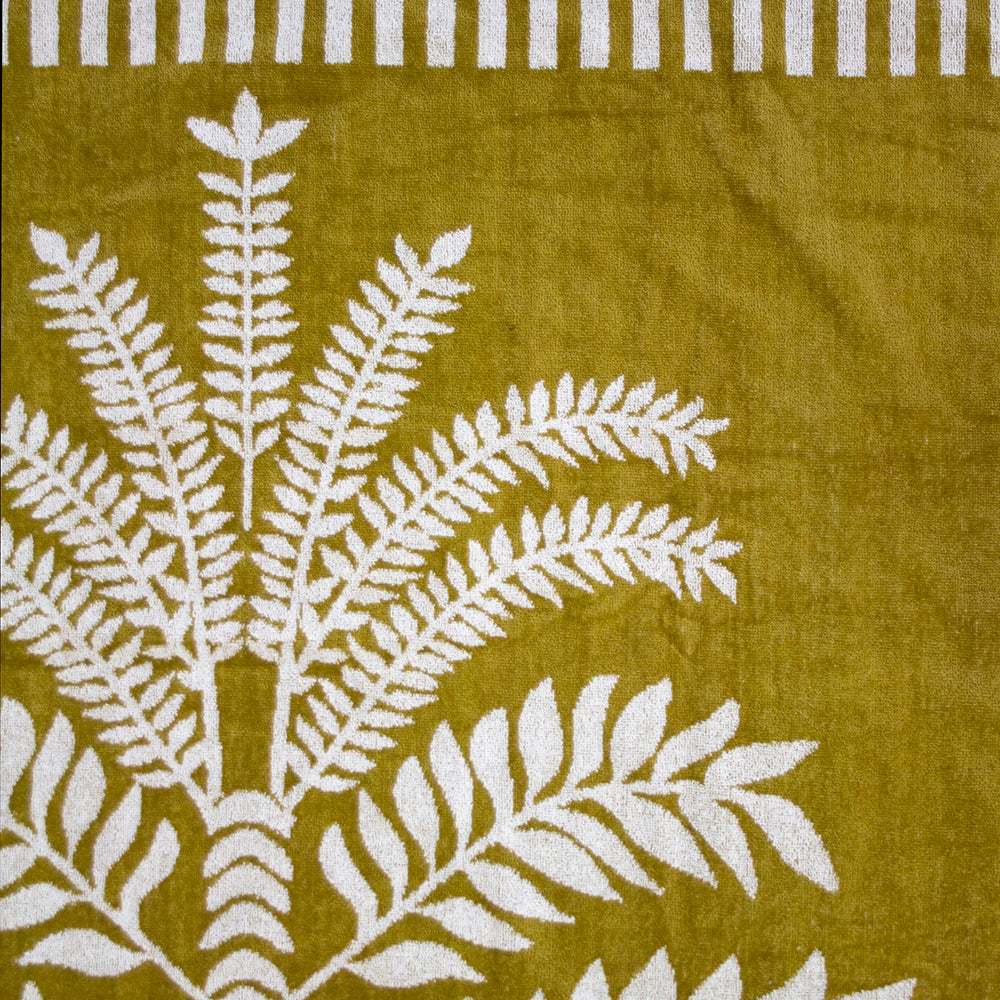 Luxurious oversized Playa Beach Towel, soft cotton with velour finish and natural fringing, perfect for beach and pool lounging.