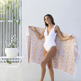 Luxurious oversized Tamarindo Beach Towel in soft Egyptian cotton with velour finish and stylish fringing, perfect for beach outings.
