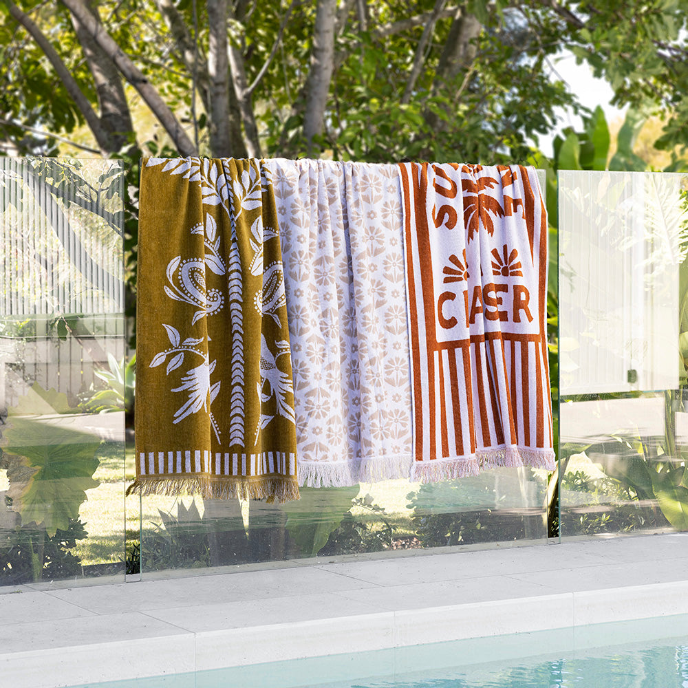 Luxurious oversized Tamarindo Beach Towel in soft Egyptian cotton with velour finish and chic natural fringing, perfect for summer.