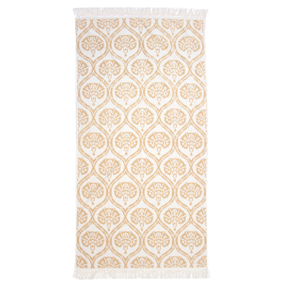 Luxurious Tamarindo Beach Towel in Egyptian cotton, oversized with velour finish, featuring chic fringing for stylish sunbathing.