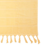 Luxurious custard beach towel with classic stripes, knotted tassels, and absorbent cotton, perfect for beach or pool outings.