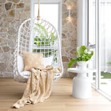 Hand-crocheted cotton throw in custard, featuring a floral motif; perfect for adding warmth to any home decor.