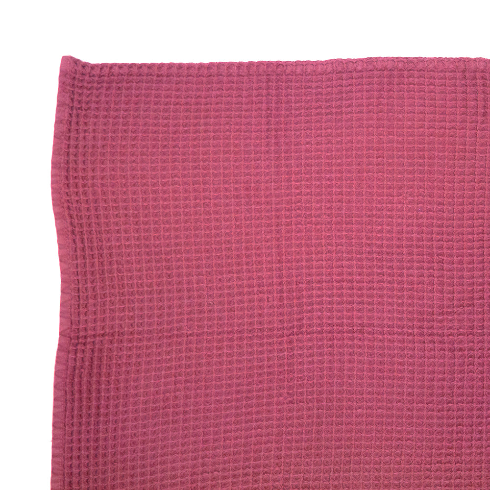 Soft pink cotton waffle throw measuring 130x180cm, perfect for adding elegance and warmth to your home decor.