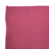 Soft pink cotton waffle throw measuring 130x180cm, perfect for adding elegance and warmth to your home decor.