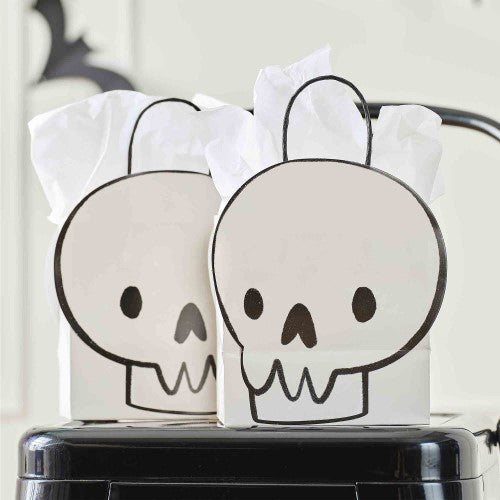 Skull-shaped Halloween paper party bags, eco-friendly, 6 per pack, ideal for trick-or-treating or spooky gatherings.