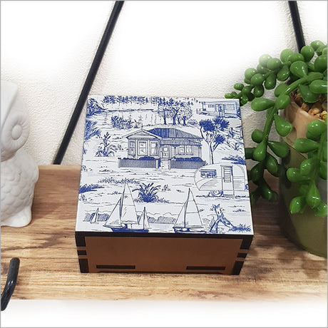 Small square trinket box featuring a villa landscape design on sustainable NZ Rimu and Pine veneer, measuring 80mm x 80mm x 40mm.