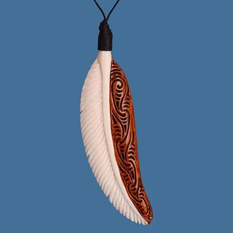 Bone Feather Pendant with intricate carvings, stained detailing, and unique character; perfect for nature lovers.