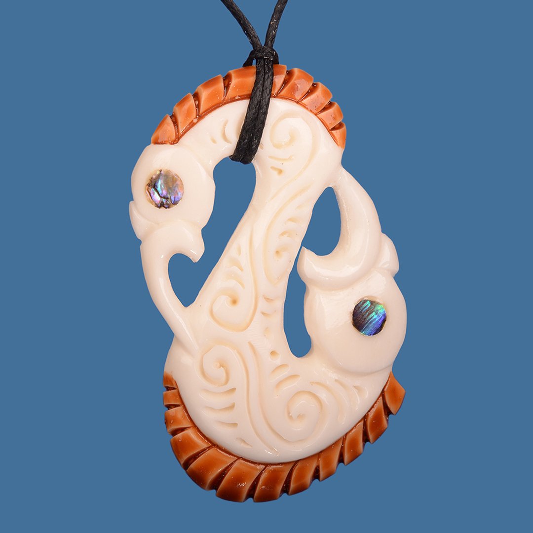 Bone Double Head Manaia Pendant showcasing intricate Maori carvings on a black wax cord, symbolizing protection and heritage.