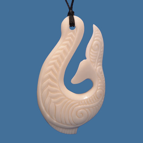 Bone Hook Pendant in elegant shape, intricately carved, on an adjustable black cord, symbolizing good fortune and safe travels.