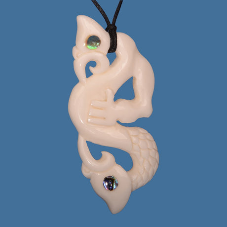 Bone Double Manaia Pendant in white, hand-carved Maori design, symbolizing protection and balance, suspended on an adjustable wax cord.