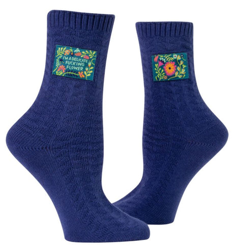 Playful large/extra-large Blue Q tag socks with a cheeky flower design, made from organic cotton and spandex for ultimate comfort.