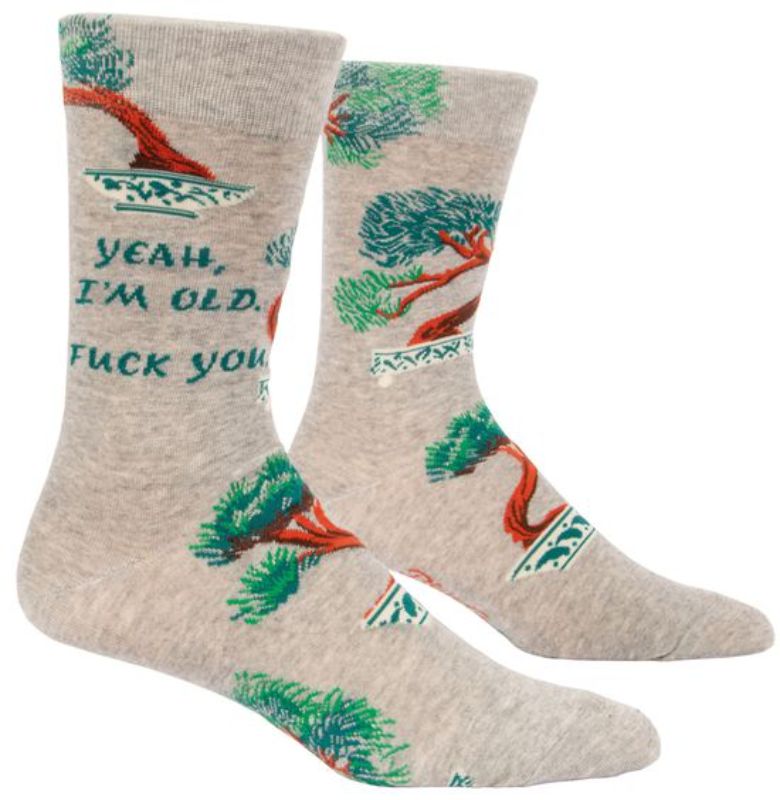 Humorous Blue Q men's socks in vibrant colors featuring "Yeah, I'm Old" for comfort and style, fitting shoe sizes 7-12.