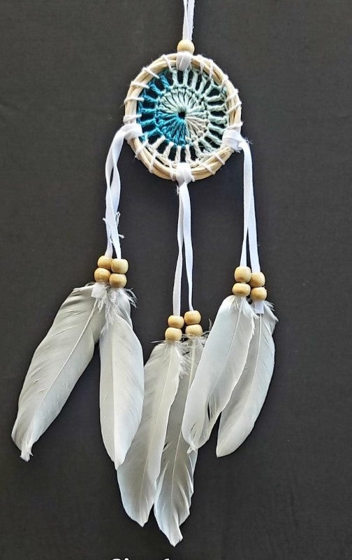 Set of 4 white 6cm dream catchers featuring intricate web designs and feathers, perfect for decor and promoting restful sleep.