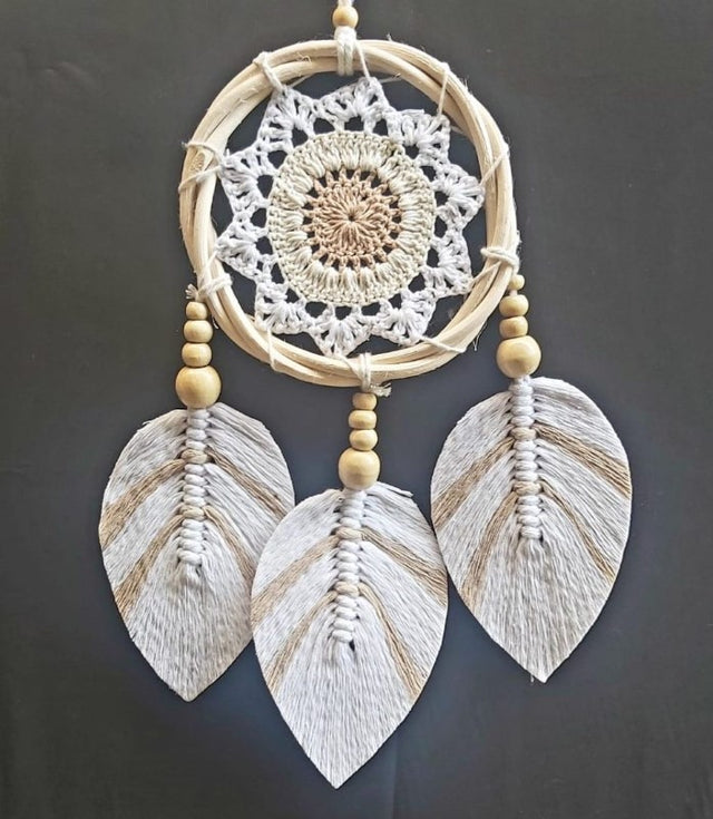 Handcrafted 12cm dreamcatcher combining crochet cotton and rattan, perfect for bohemian home decor and promoting positivity.