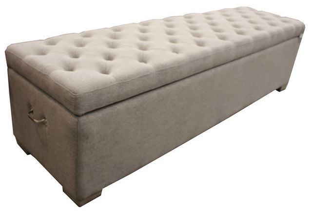 Grey linen ottoman blanket box with timber frame and metal handles, offering stylish storage in a modern bedroom.