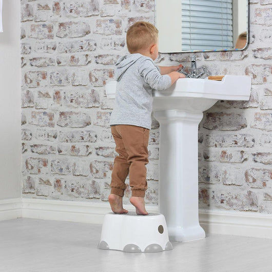 Bumbo Step n' Potty in Cool Grey, a versatile 2-in-1 potty trainer with soft seat and built-in step stool for toddlers.