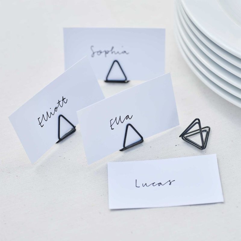 Stylish black wire place card holders for weddings, ideal for displaying seating arrangements and menus elegantly.