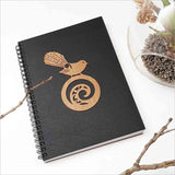 A5 black journal featuring a New Zealand fantail on a koru, perfect for jotting down thoughts and creative ideas.