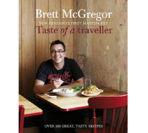 Cookbook 'Taste of a Traveller' by Brett McGregor featuring vibrant recipes inspired by global culinary travels.