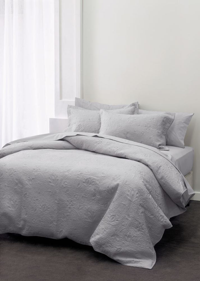 Luxurious single bedspread in grey with intricate stitching, crafted from 100% cotton for comfort and elegance.