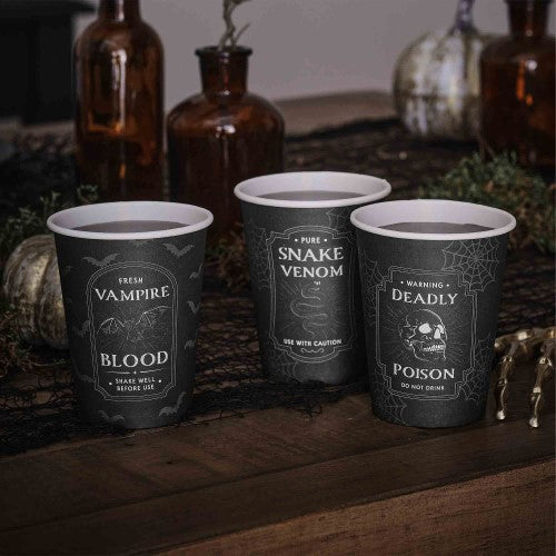 Spooky black paper cups with potion labels, perfect for Halloween parties, eco-friendly and stylish.