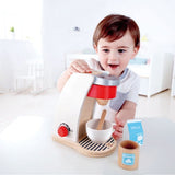 A colorful toy coffee machine with accessories for imaginative play, perfect for children aged 24 months and up.