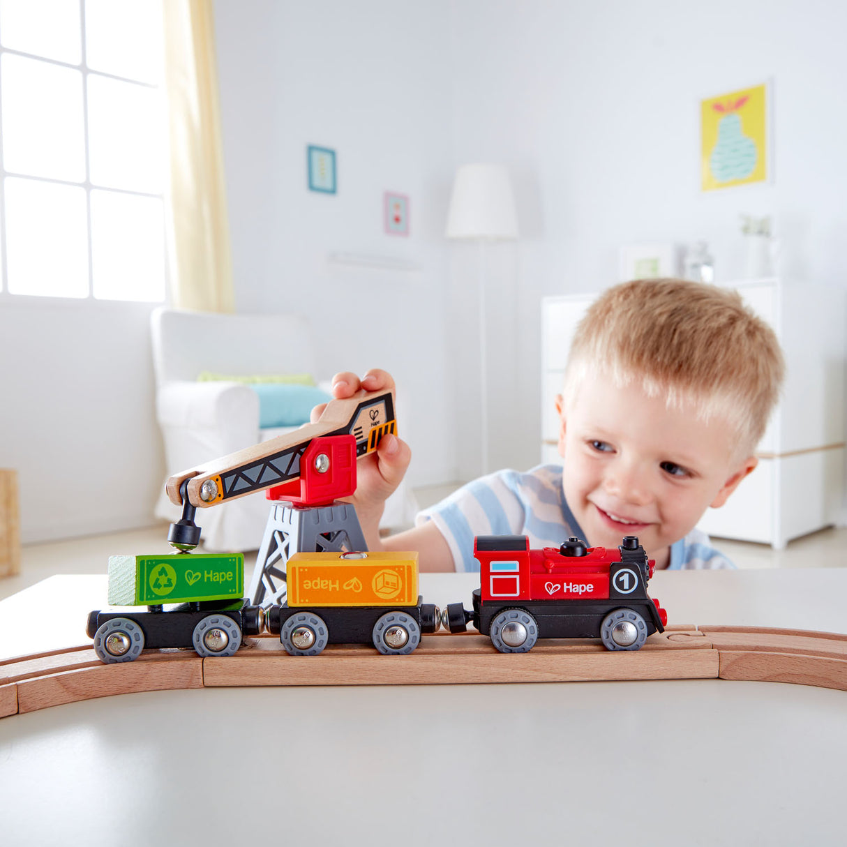 Colorful Hape Cargo Delivery Loop train set with magnetic crane, oval track, and engaging features for imaginative play.