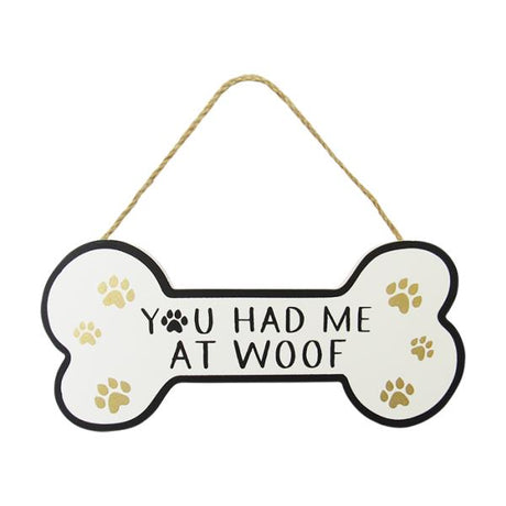Dog bone-shaped wall art with twine hanger, featuring paw prints and "You had me at woof" for dog lovers.