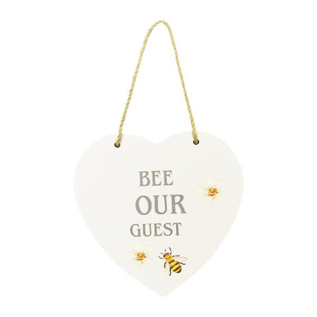 Bee-themed heart-shaped wall art sign with 'Bee Our Guest' phrase, adding charm and warmth to any space.