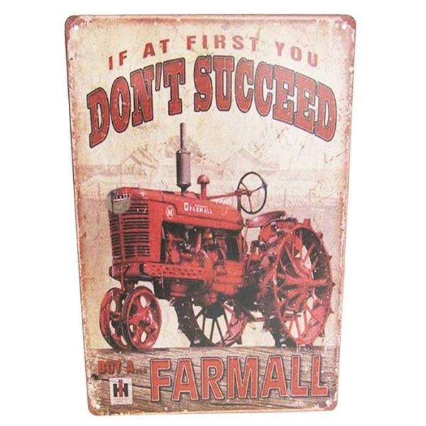 Vintage-style tin sign featuring an iconic tractor design, perfect for rustic home decor or man caves.