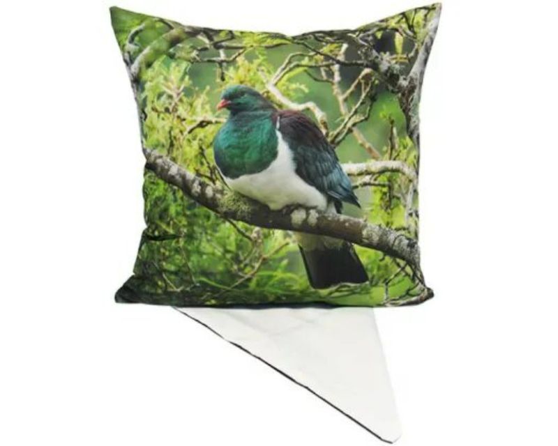 Cushion cover featuring a vibrant Kereru design, perfect for adding elegance and nature to any living space.