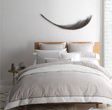 Super King Duvet Cover Set in Essex Stone, featuring herringbone pattern and chic black piping, perfect for elegant bedrooms.