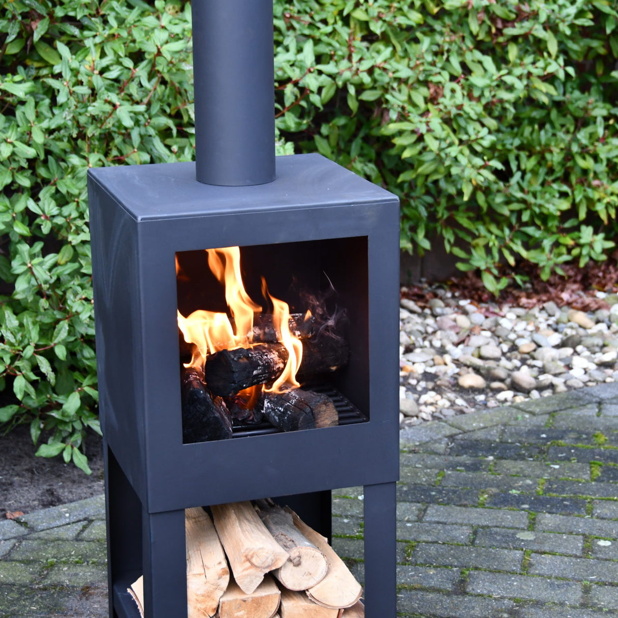 Sleek black terrace heater with storage, 136cm tall, perfect for outdoor warmth and style during chilly evenings.