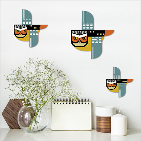 Set of 3 Ruru wall art pieces in vibrant colors on brushed silver, embodying Kiwiana culture for stylish home decor.