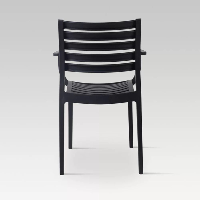 Stylish charcoal dining chair made of UV stabilized resin, lightweight, stackable, and supports up to 140kg.