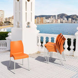 Vibrant orange Vita Chair featuring a recyclable seat, anodized legs, perfect for stylish indoor and outdoor use.