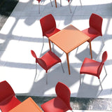 Vita Chair in red featuring a recyclable polypropylene seat, anodized aluminium legs, ideal for indoor and outdoor use.