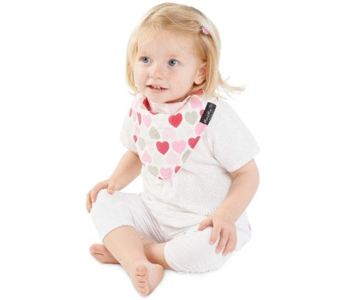 Reversible baby bib in baby pink with muted hearts, featuring waterproof layers and super absorbent cotton for easy clean-up.